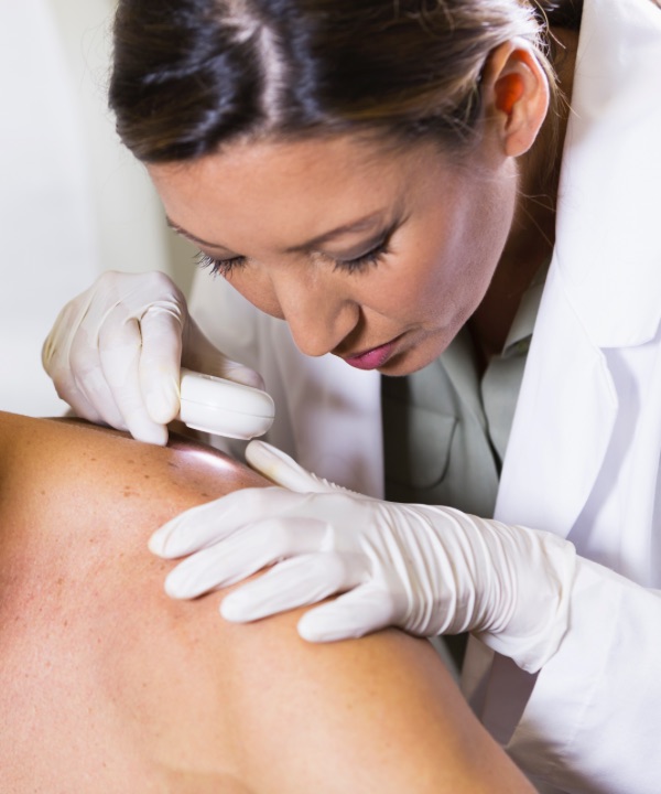 Dermatologist examining skin